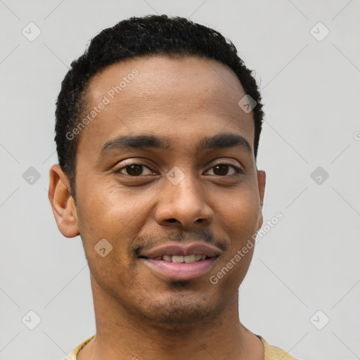 Joyful black young-adult male with short  black hair and brown eyes