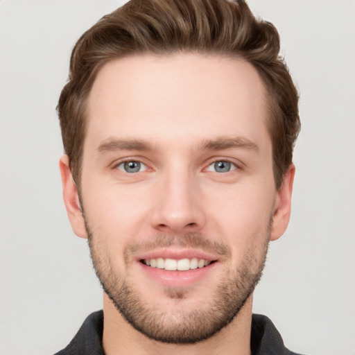 Joyful white young-adult male with short  brown hair and grey eyes