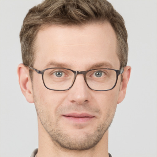 Joyful white adult male with short  brown hair and grey eyes