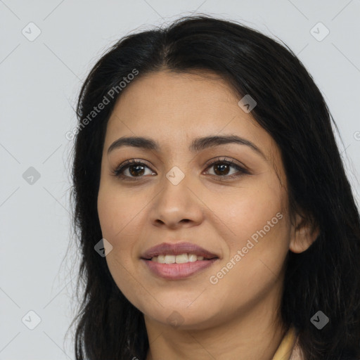 Joyful latino young-adult female with long  brown hair and brown eyes