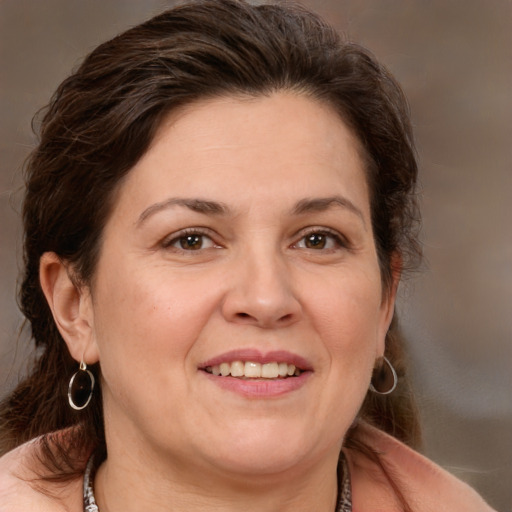 Joyful white adult female with medium  brown hair and brown eyes