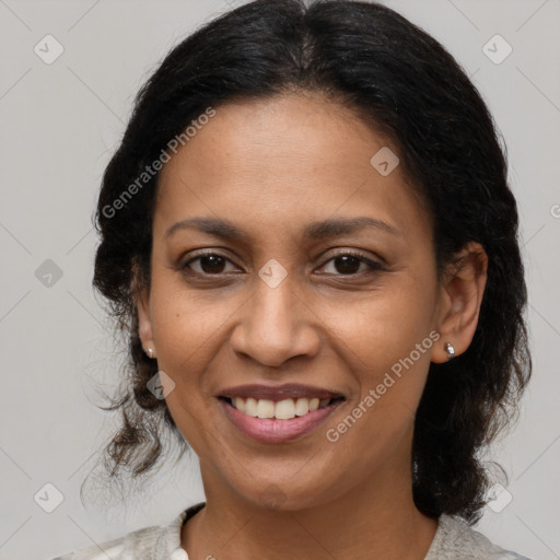 Joyful latino adult female with medium  brown hair and brown eyes