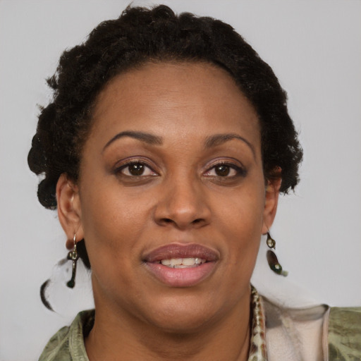 Joyful black adult female with short  brown hair and brown eyes