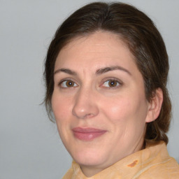 Joyful white adult female with medium  brown hair and brown eyes