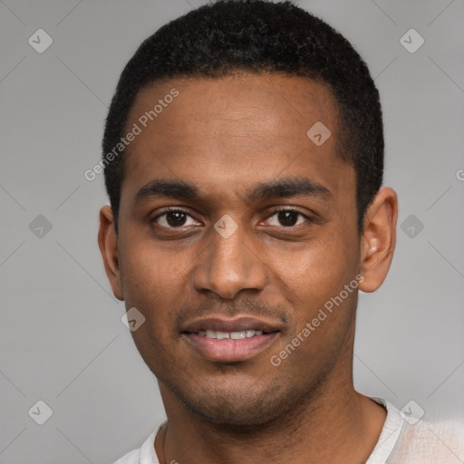 Joyful black young-adult male with short  black hair and brown eyes