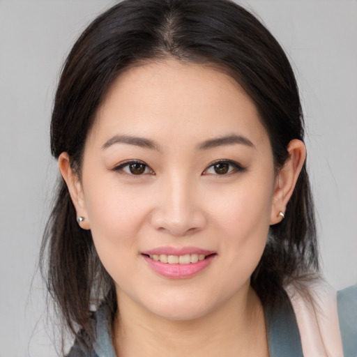 Joyful white young-adult female with medium  brown hair and brown eyes