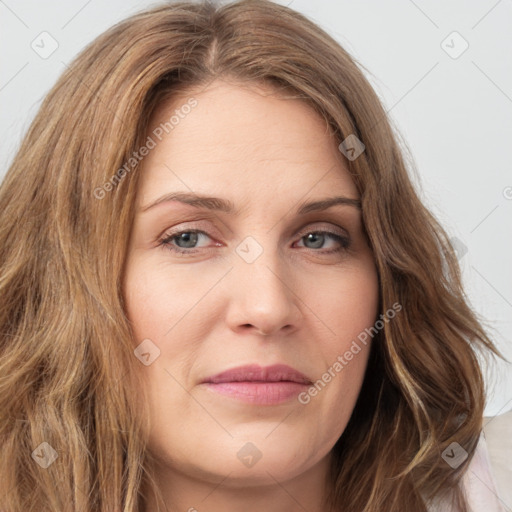 Joyful white young-adult female with long  brown hair and green eyes