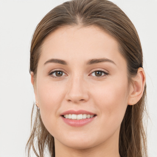 Joyful white young-adult female with long  brown hair and grey eyes