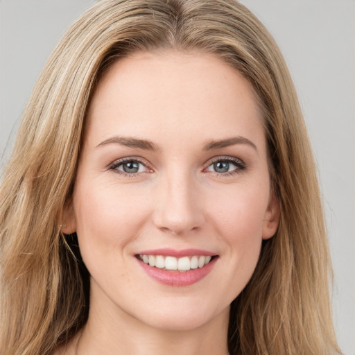 Joyful white young-adult female with long  brown hair and green eyes