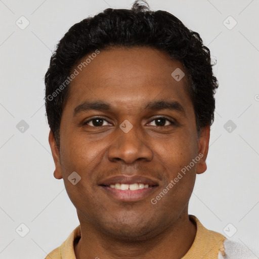 Joyful black young-adult male with short  black hair and brown eyes