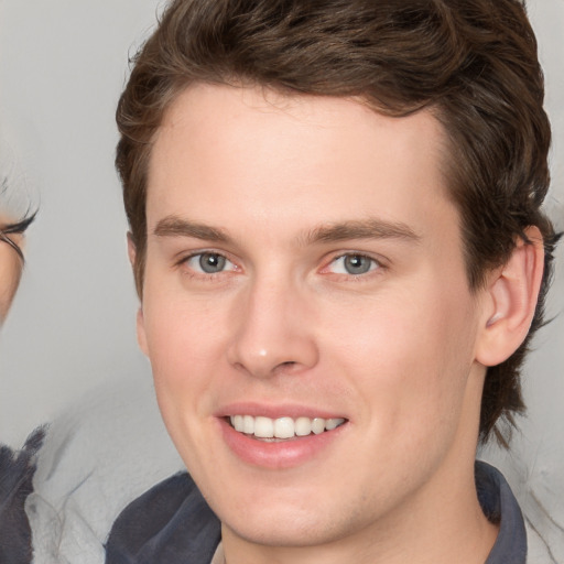 Joyful white young-adult male with medium  brown hair and brown eyes