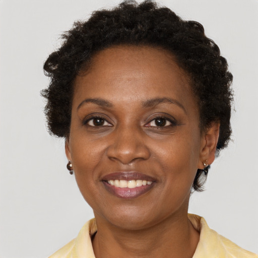 Joyful black adult female with short  brown hair and brown eyes