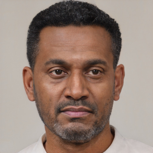 Neutral latino adult male with short  black hair and brown eyes