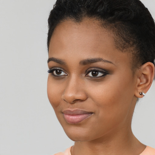 Joyful black young-adult female with short  brown hair and brown eyes