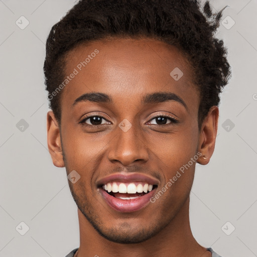 Joyful black young-adult male with short  brown hair and brown eyes