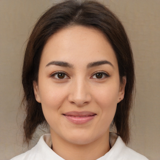 Joyful white young-adult female with medium  brown hair and brown eyes