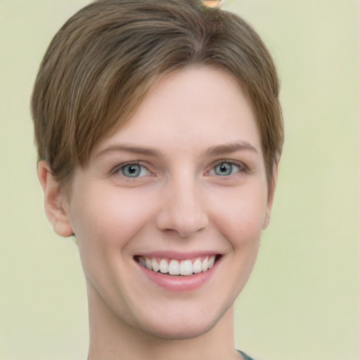 Joyful white young-adult female with short  brown hair and green eyes