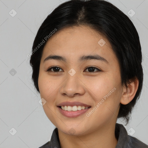 Joyful asian young-adult female with medium  black hair and brown eyes