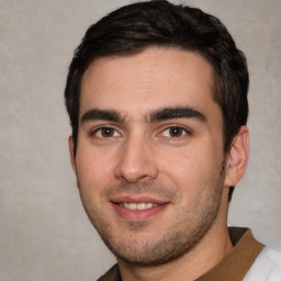 Joyful white young-adult male with short  black hair and brown eyes