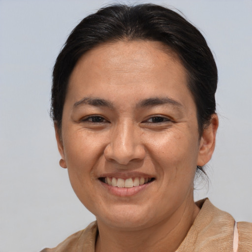 Joyful white adult female with medium  brown hair and brown eyes