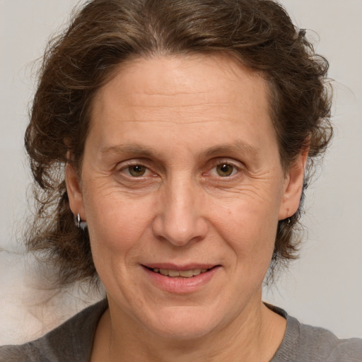 Joyful white middle-aged female with medium  brown hair and brown eyes
