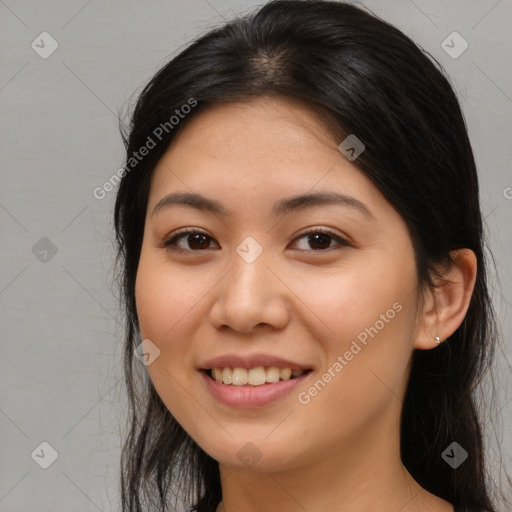 Joyful asian young-adult female with long  brown hair and brown eyes