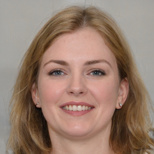 Joyful white young-adult female with medium  brown hair and blue eyes