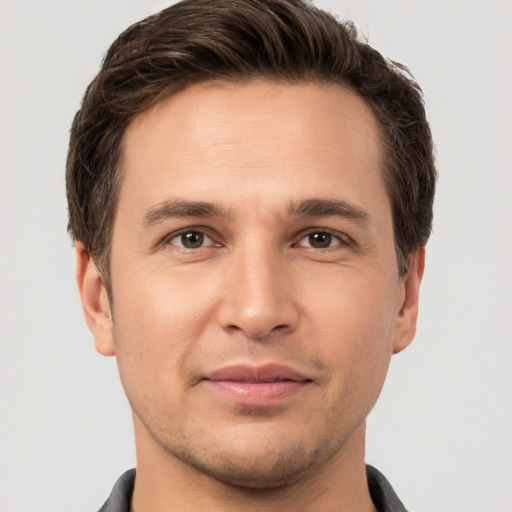 Joyful white young-adult male with short  brown hair and brown eyes