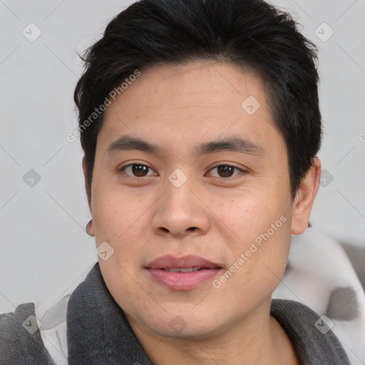 Joyful asian young-adult male with short  brown hair and brown eyes