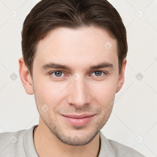 Joyful white young-adult male with short  brown hair and grey eyes