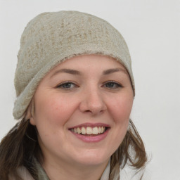 Joyful white young-adult female with long  brown hair and blue eyes