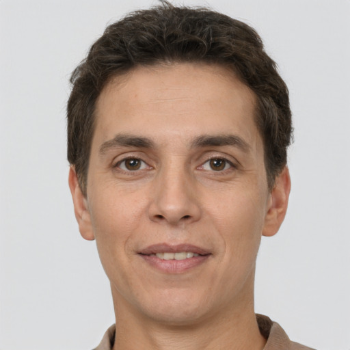 Joyful white adult male with short  brown hair and brown eyes