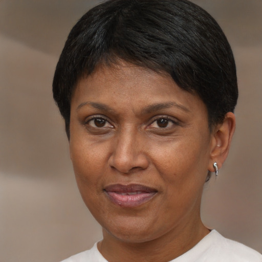 Joyful black adult female with short  brown hair and brown eyes