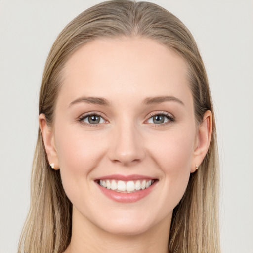 Joyful white young-adult female with long  brown hair and grey eyes