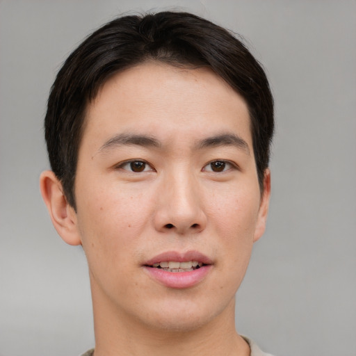 Joyful asian young-adult male with short  brown hair and brown eyes