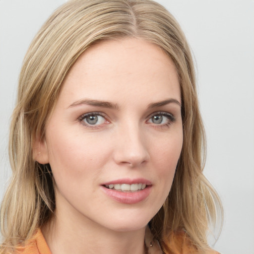 Joyful white young-adult female with medium  brown hair and blue eyes