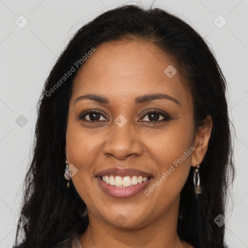 Joyful black young-adult female with long  brown hair and brown eyes