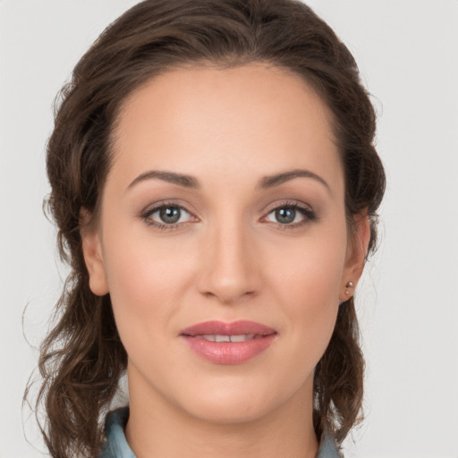 Joyful white young-adult female with medium  brown hair and grey eyes