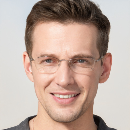 Joyful white adult male with short  brown hair and grey eyes