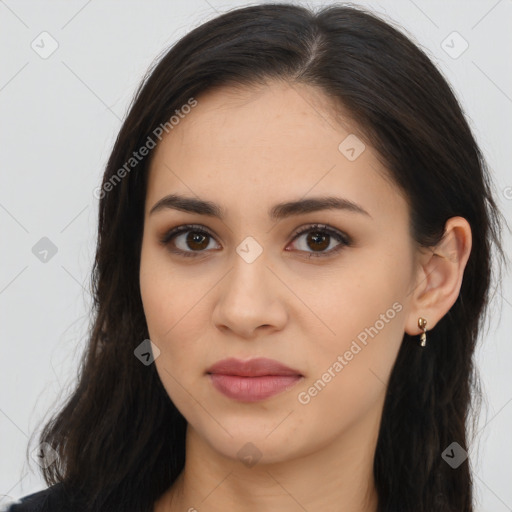 Joyful latino young-adult female with long  brown hair and brown eyes