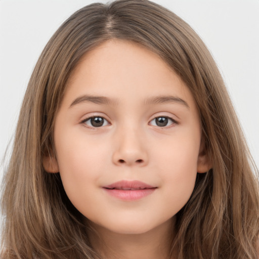 Joyful white child female with long  brown hair and brown eyes