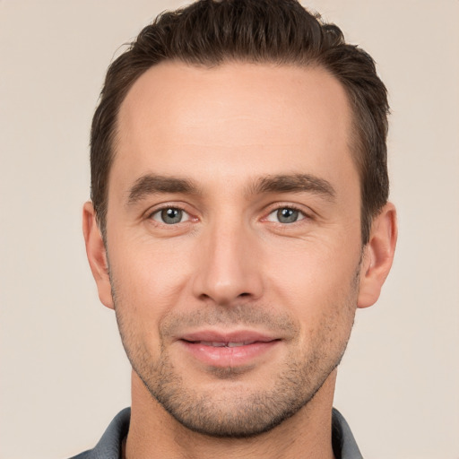 Joyful white young-adult male with short  brown hair and brown eyes