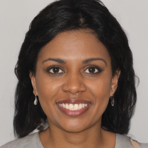 Joyful black young-adult female with medium  black hair and brown eyes