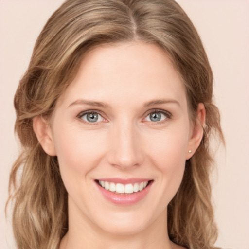 Joyful white young-adult female with medium  brown hair and blue eyes