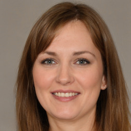 Joyful white young-adult female with long  brown hair and brown eyes