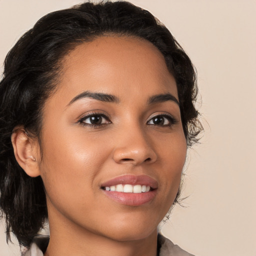 Joyful latino young-adult female with medium  brown hair and brown eyes