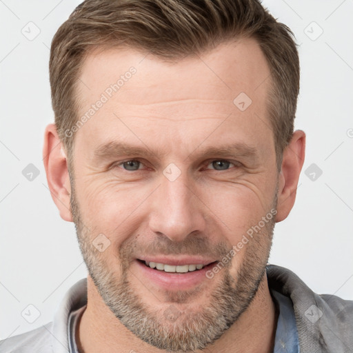 Joyful white adult male with short  brown hair and grey eyes