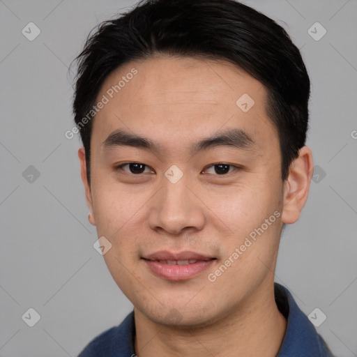 Joyful asian young-adult male with short  black hair and brown eyes