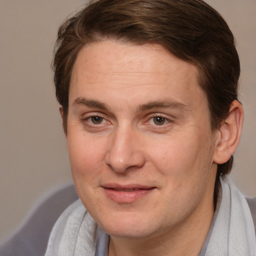 Joyful white adult male with short  brown hair and brown eyes