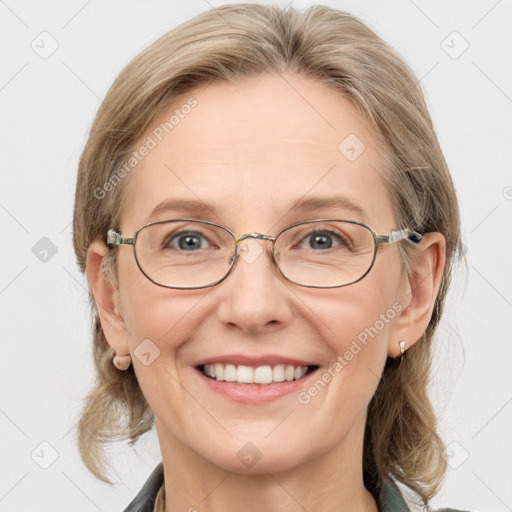 Joyful white adult female with medium  brown hair and blue eyes